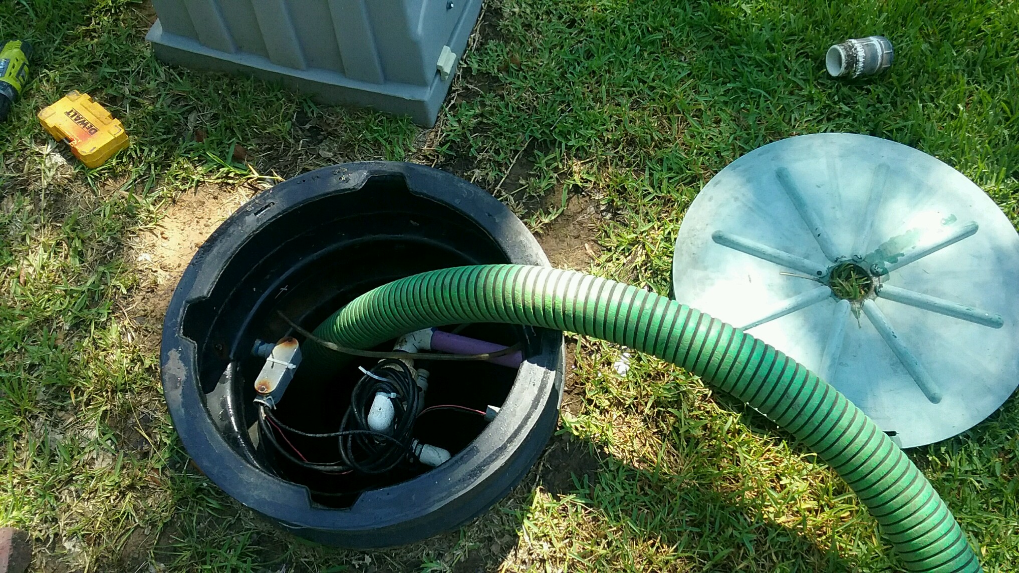 Septic technician pumping out a residential septic tank with professional vacuum equipment