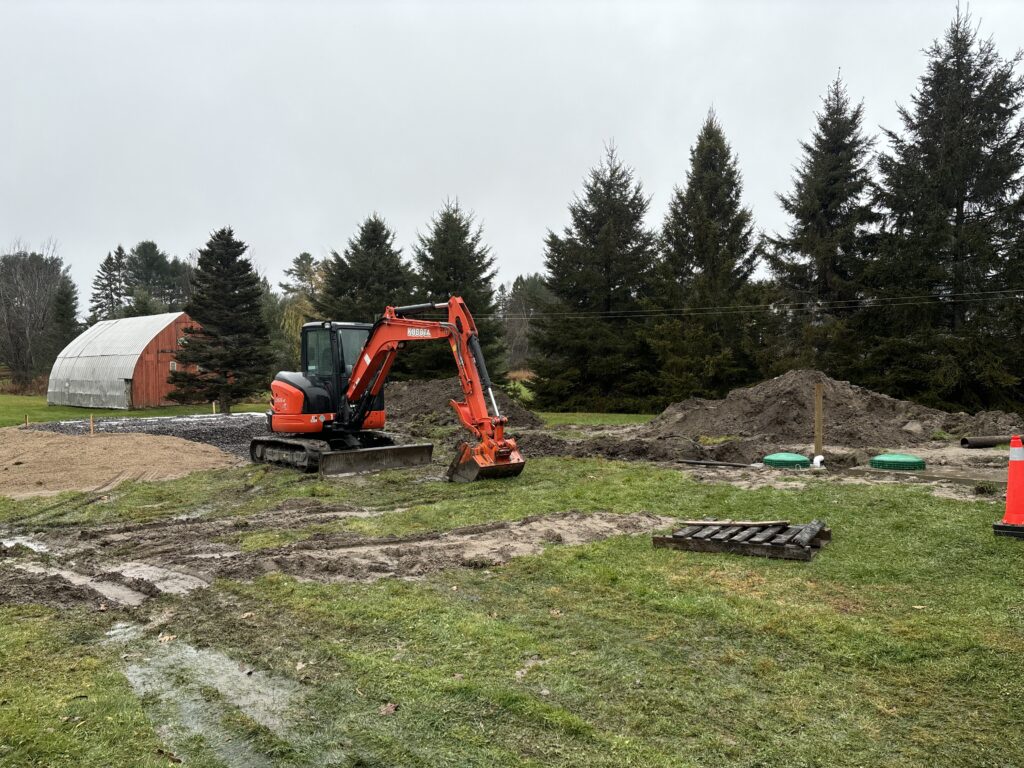 Technician repairing a septic tank lid and inspecting for leaks